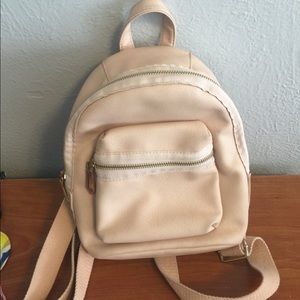Light pink creamy colored backpack purse